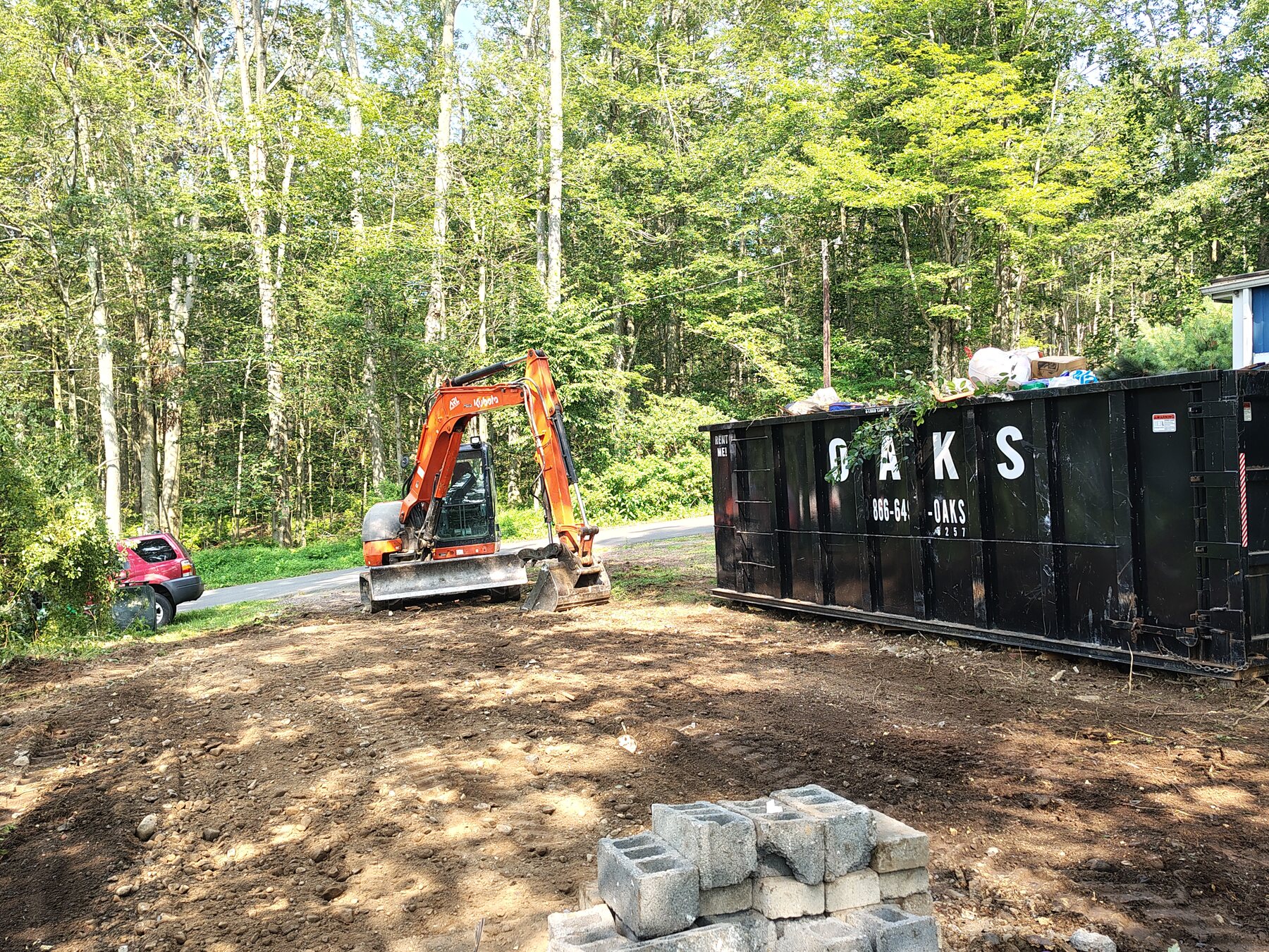 Mobile-home demolition and site clearing: After — debris loaded and site cleared