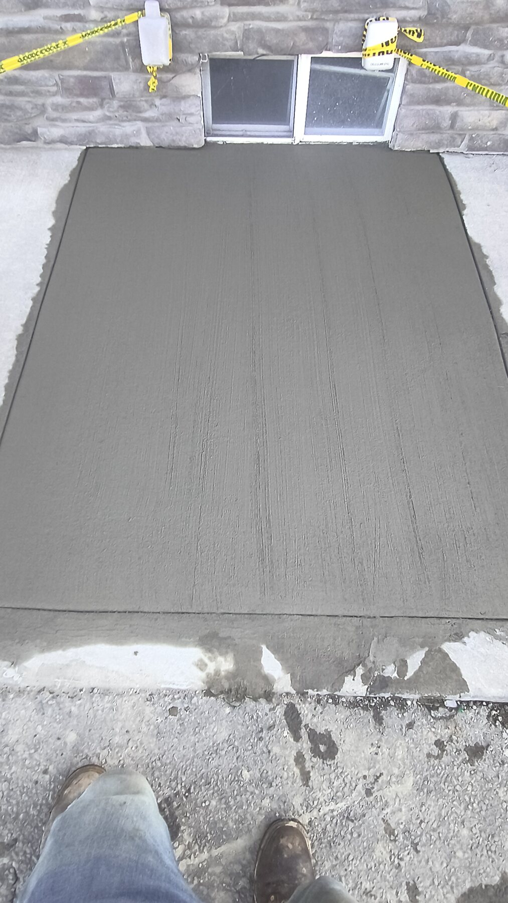 Exterior drainage and access restoration: After — stabilized concrete surface