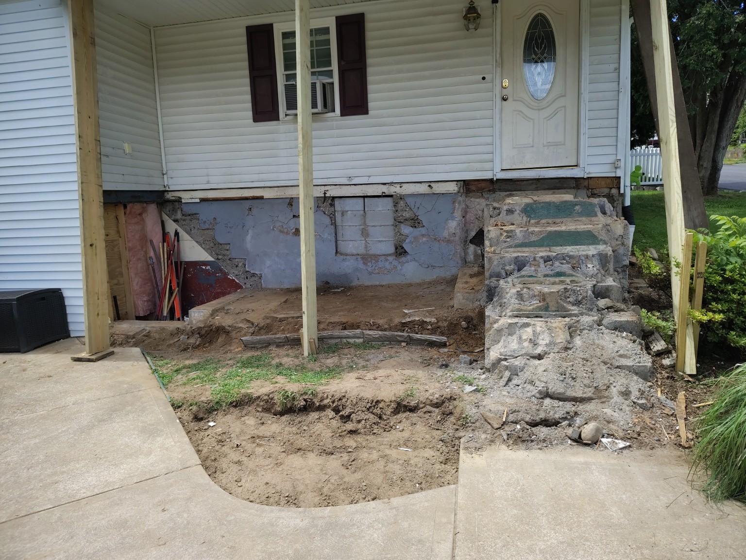 Porch removed to expose the foundation and prepare the front of the house for rebuilding